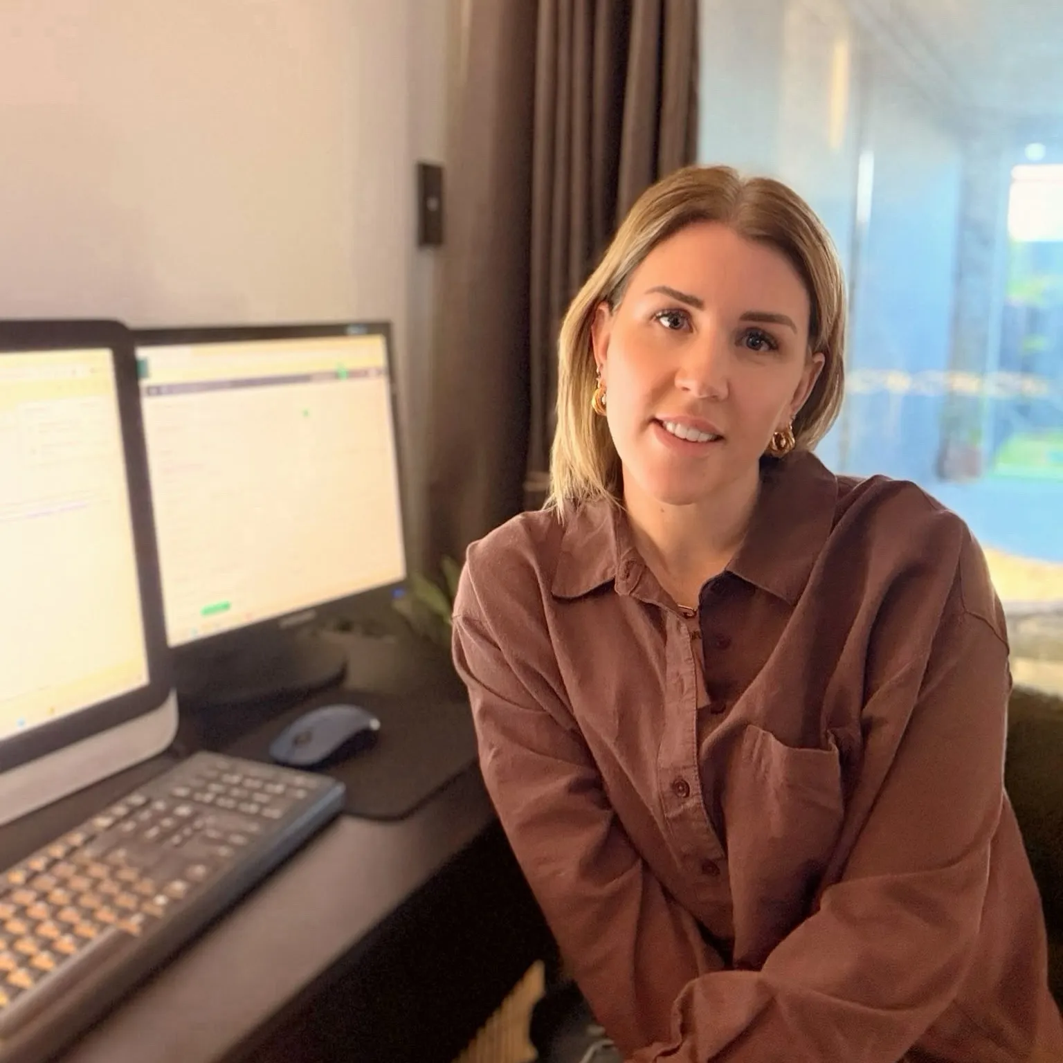 Rebecca sitting at her desk at home
