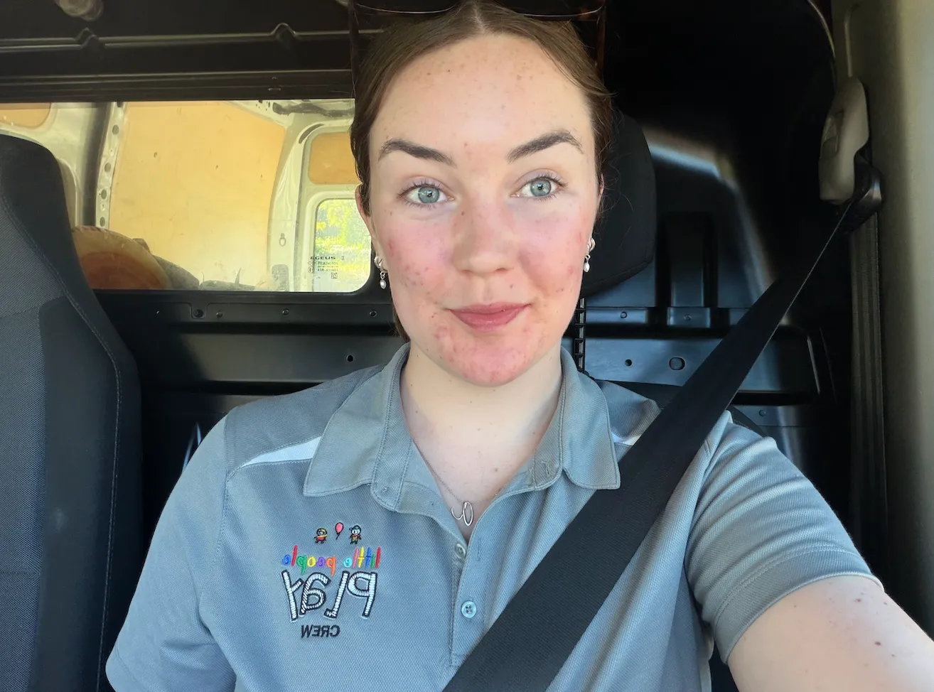 Annelise smiling in the front seat of a delivery vehicle